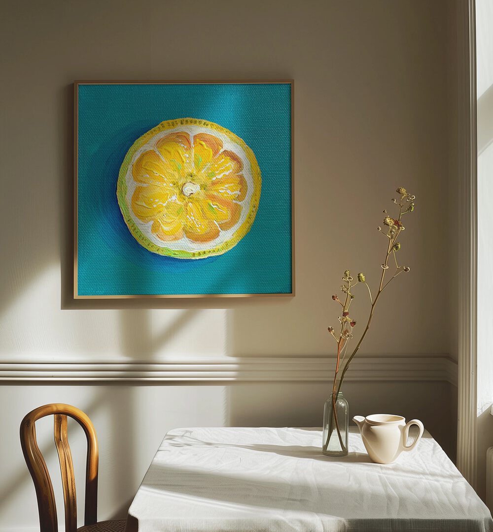 Lemon Slice By Key And Sea Creative Art Print in Oak Wood Plain Frame on a white wall beside a dining table