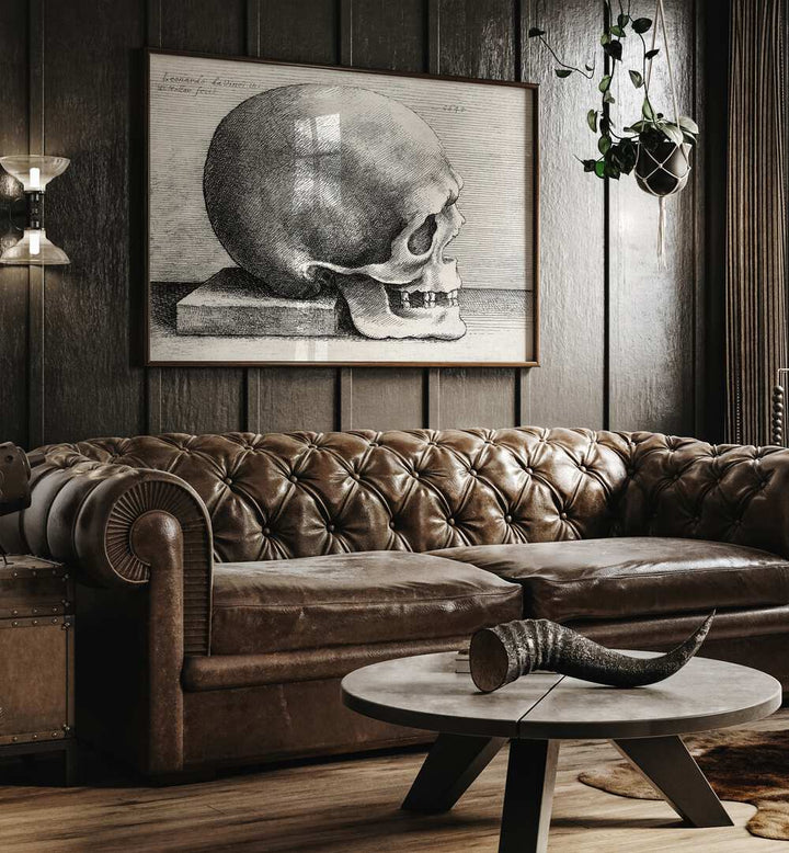 Leonardo Da Vincis Skull In Profile To Right 1645 Vintage Paintings in Dark Oakwood Plain Frame placed on a wall behind a brown sofa 