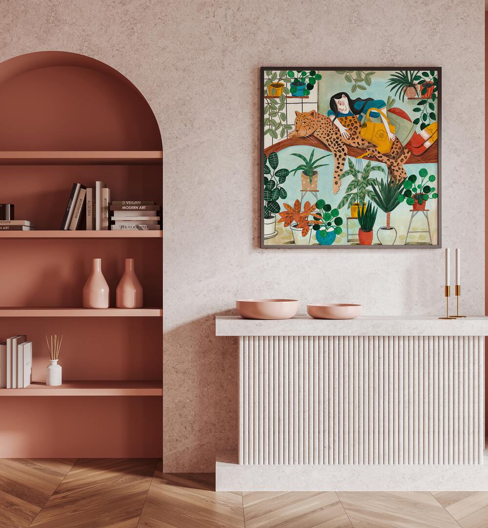 Leopard and Gardening By Caroline Bonne Muller Woman Illustration Paintings in Dark Wood Plain Frame on a pink wall above a  table