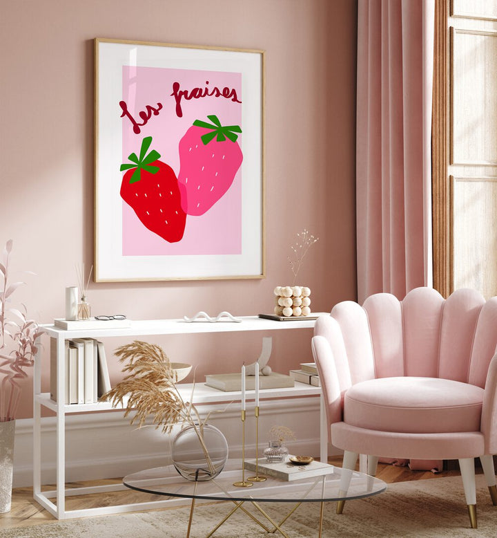 Les Fraises by Athene Fritsch Kitchen Posters Kitchen Art Prints in Oak Wood Plain Frame placed on a pink wall beside a window and behind a table