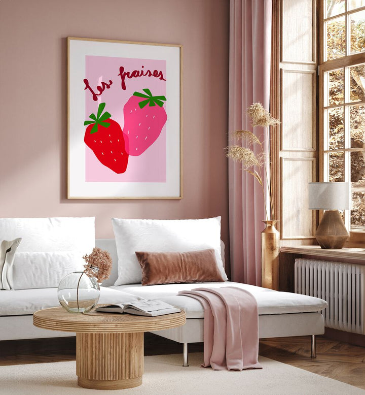 Les Fraises by Athene Fritsch Kitchen Posters Kitchen Art Prints in Oak Wood Plain Frame placed on a pink wall beside a window and behind a sofa for living room