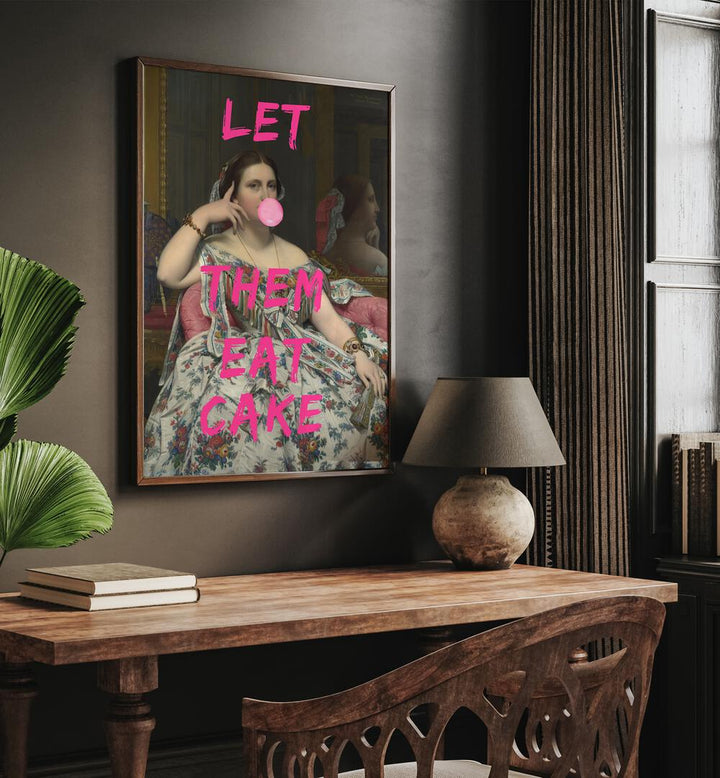 Let Them Eat Cake by the Art Concept Altered Art Prints in Oak Wood Plain Frame placed on a wall behind a study table