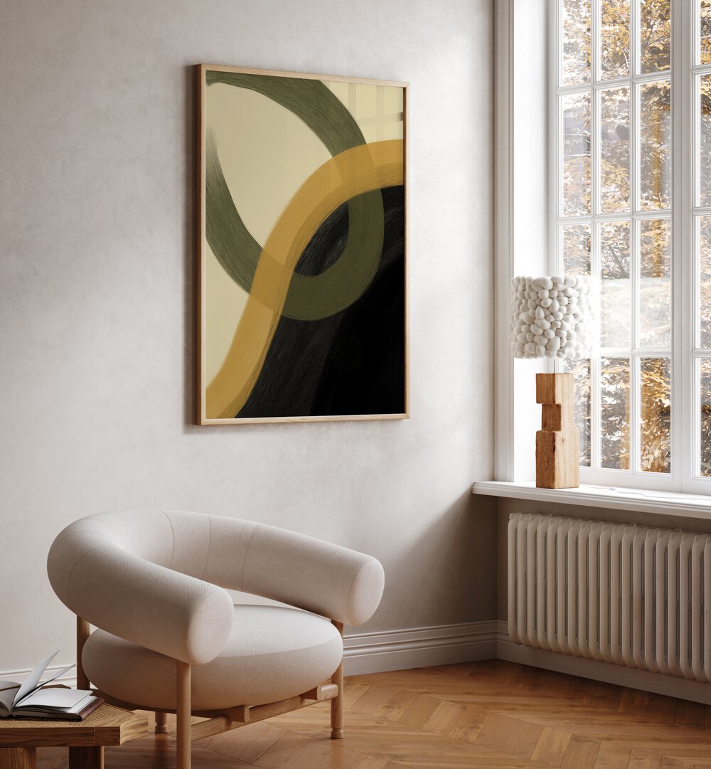 Libet by Yopie Studio Abstract Paintings Abstract Art Prints in Oak Wood Plain Frame placed on a wall beside a window and behind a chair