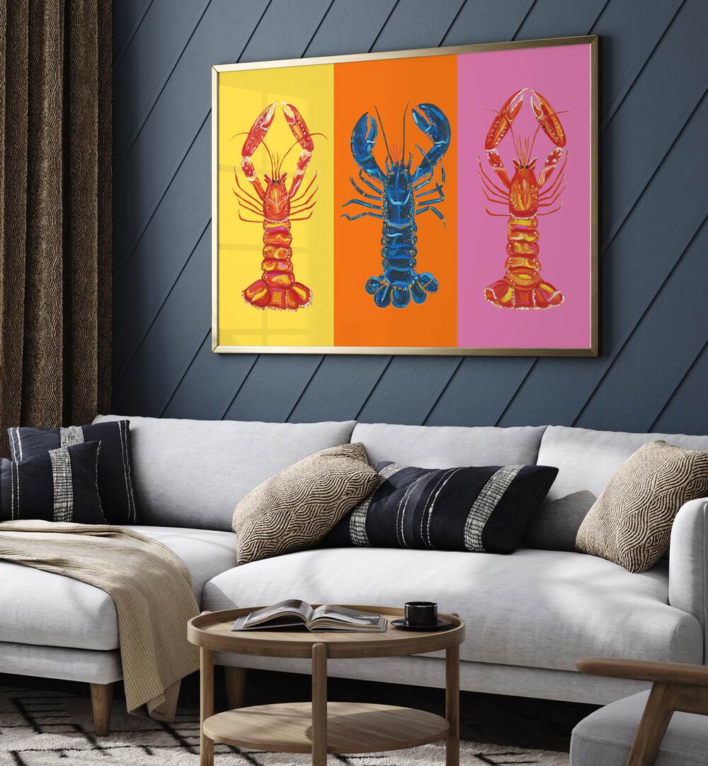 Lobster Langoustines iii by Alice Straker Pop Art Paintings Pop Art Prints in Gold Plain Frame placed on a living room wall behind a sofa