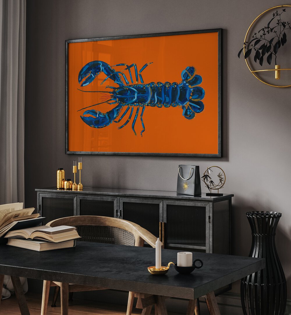 Lobster on Orange by Alice Straker Cafe Art Prints Cafe Posters in Black Plain Frame placed on a wall behind a console table