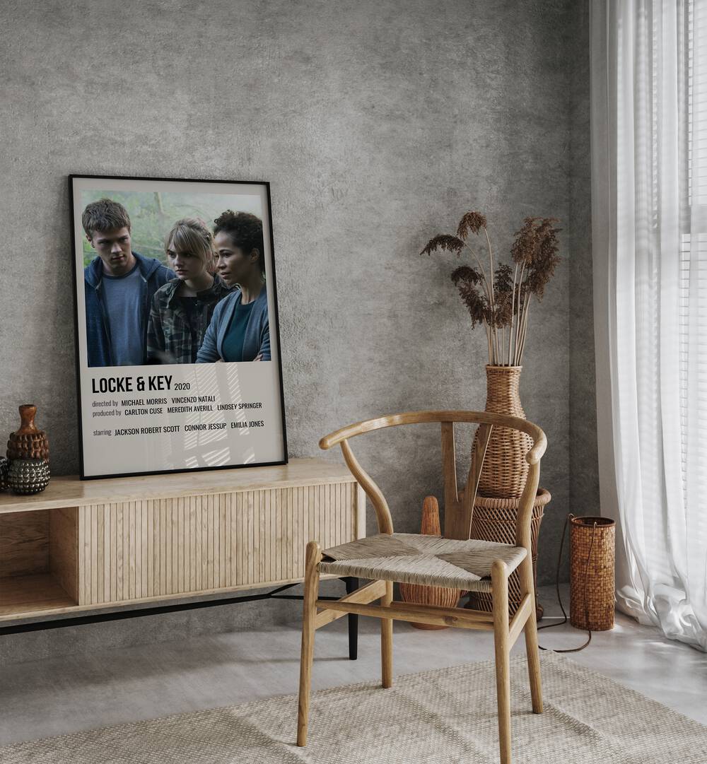 Locke Key 2020 I Movie Posters in Black Plain Frame placed on a table beside oakwood chair