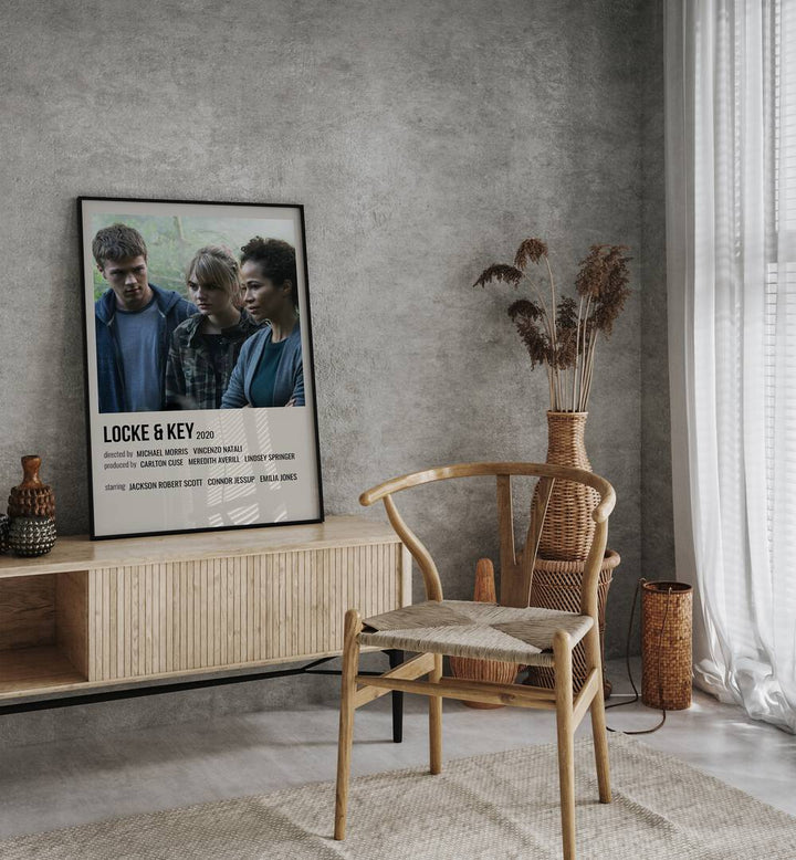 Locke Key 2020 I Movie Posters in Black Plain Frame placed on a table beside oakwood chair