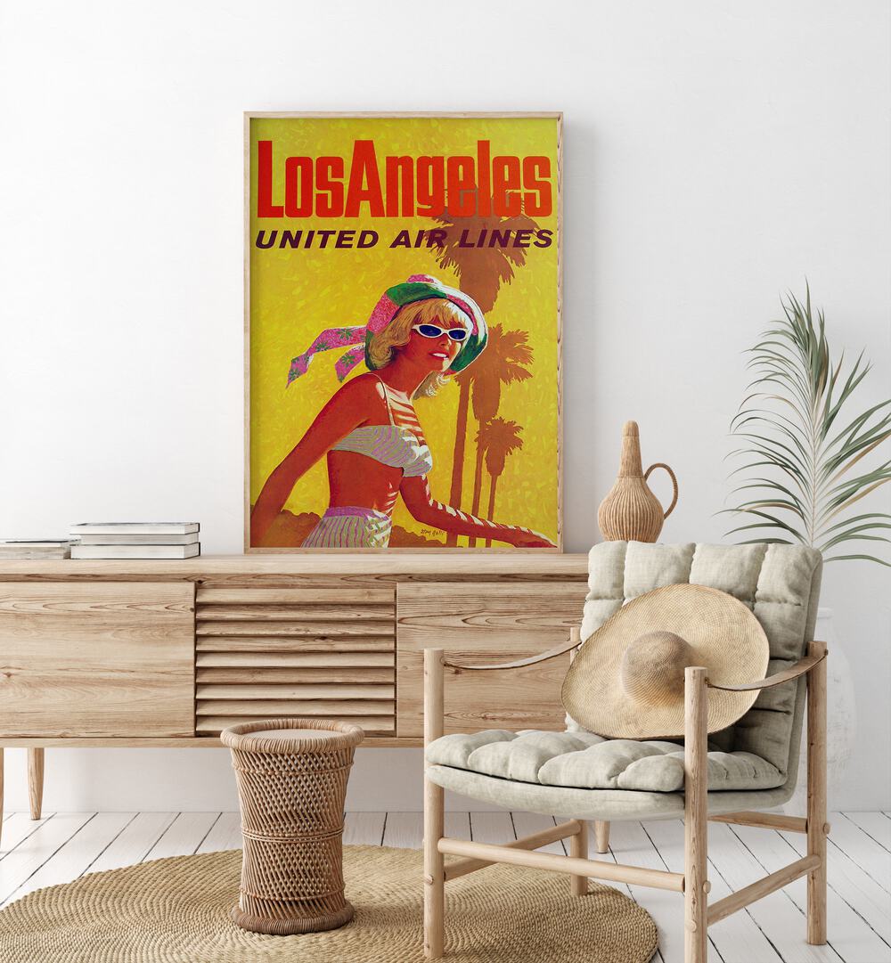 Los Angeles-United Air Lines  Travel Posters in Oak Wood Plain Frame placed on a console table behind a chair