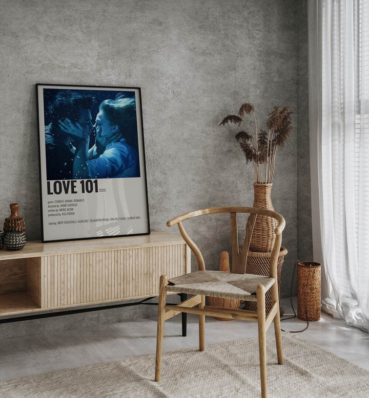 Love 101 Movie Posters in Black Plain Frame placed on a console behind a chair