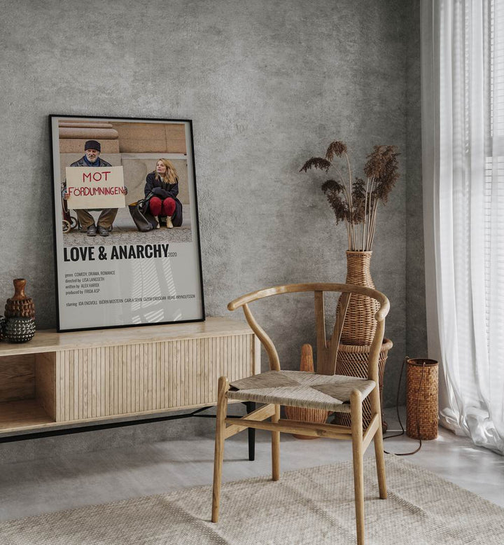 Love And Anarchy Movie Posters in Black Plain Frame placed on a console behind a chair