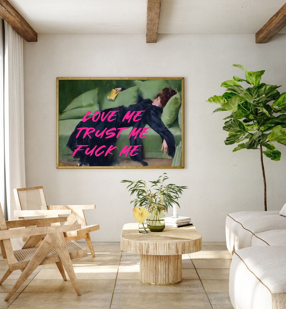 Love Me by the Art Concept Altered Art Prints in Oak Wood Plain Frame placed on a wall beside chairs