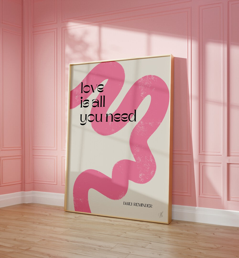 Love is All You Need by Anne-marie Volfova Quotes and Typography Posters in Oak Wood Plain Frame placed on a floor beside a window