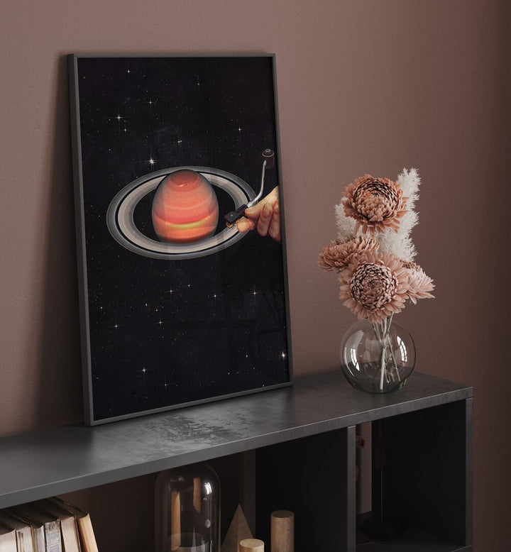 Meteor Mashup II Surreal Art Painting Artwork in plain black frame above a shelf beside a flower pot