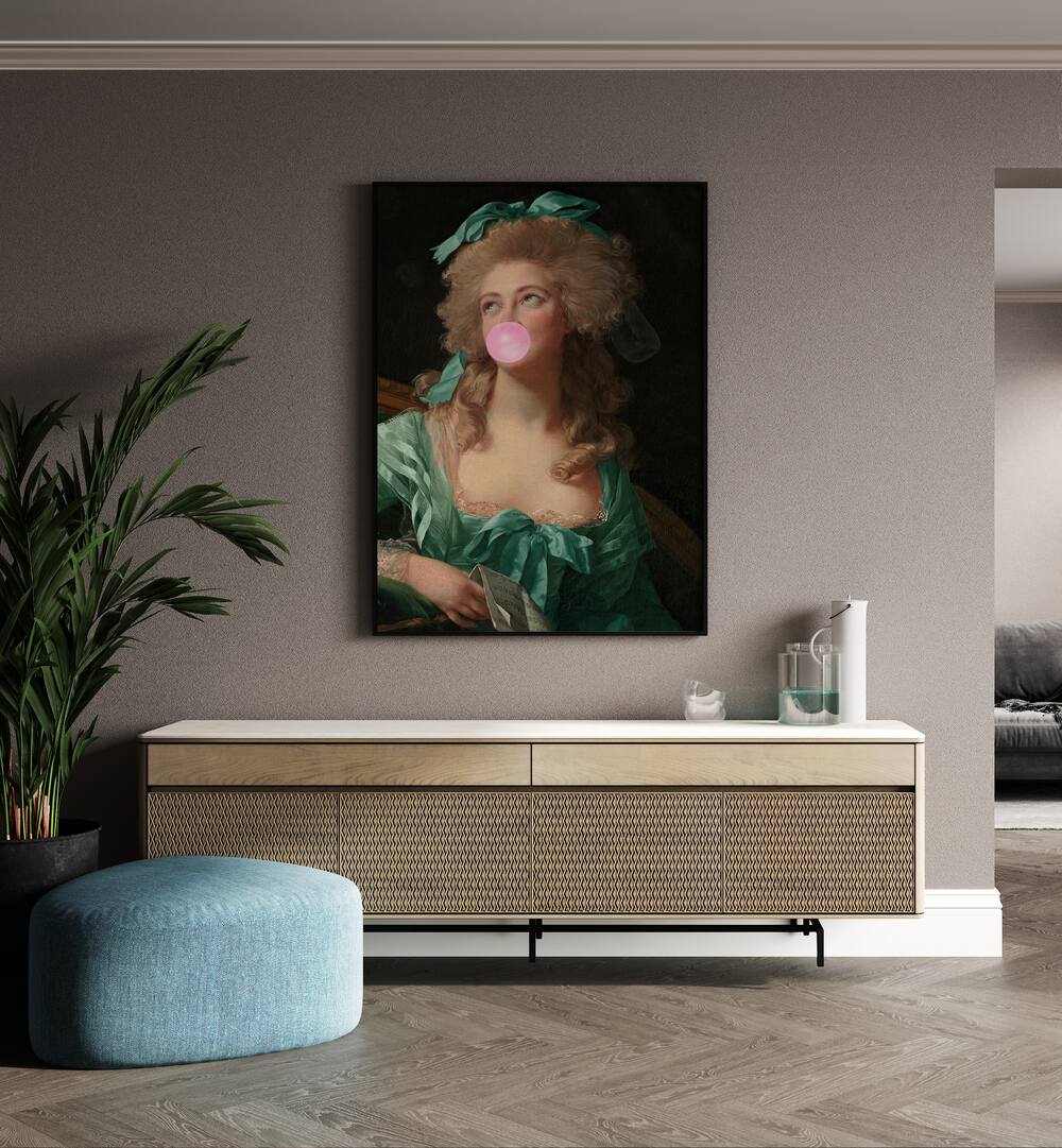 Madame Bubble-gum By Grace Digital Art Co Altered Art Prints in Black Plain Frame placed on a wall behind a console table and beside a plant