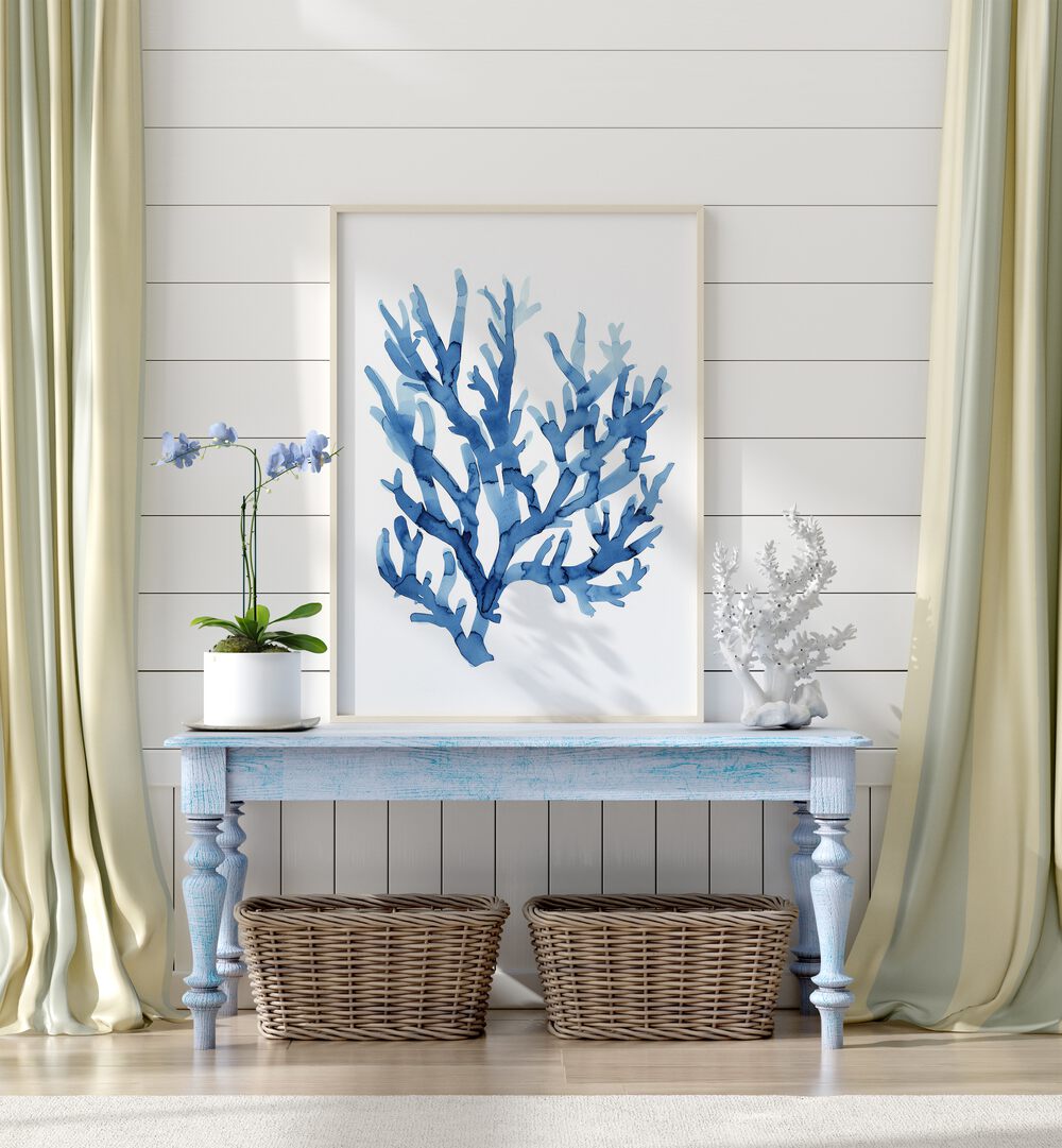 Marine Botanicals I Beach Prints Coastal Wall Art in White Plain Frame placed on a blue table beside a plant and a showpiece