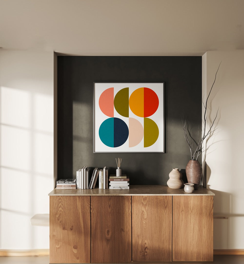 Mid Century Geometric Color Play II By Ana Rut Bre Abstract Art Abstract Paintings in Black Plain Frame placed on a Dark Grey Colored Wall above a Console Table in the Living Room