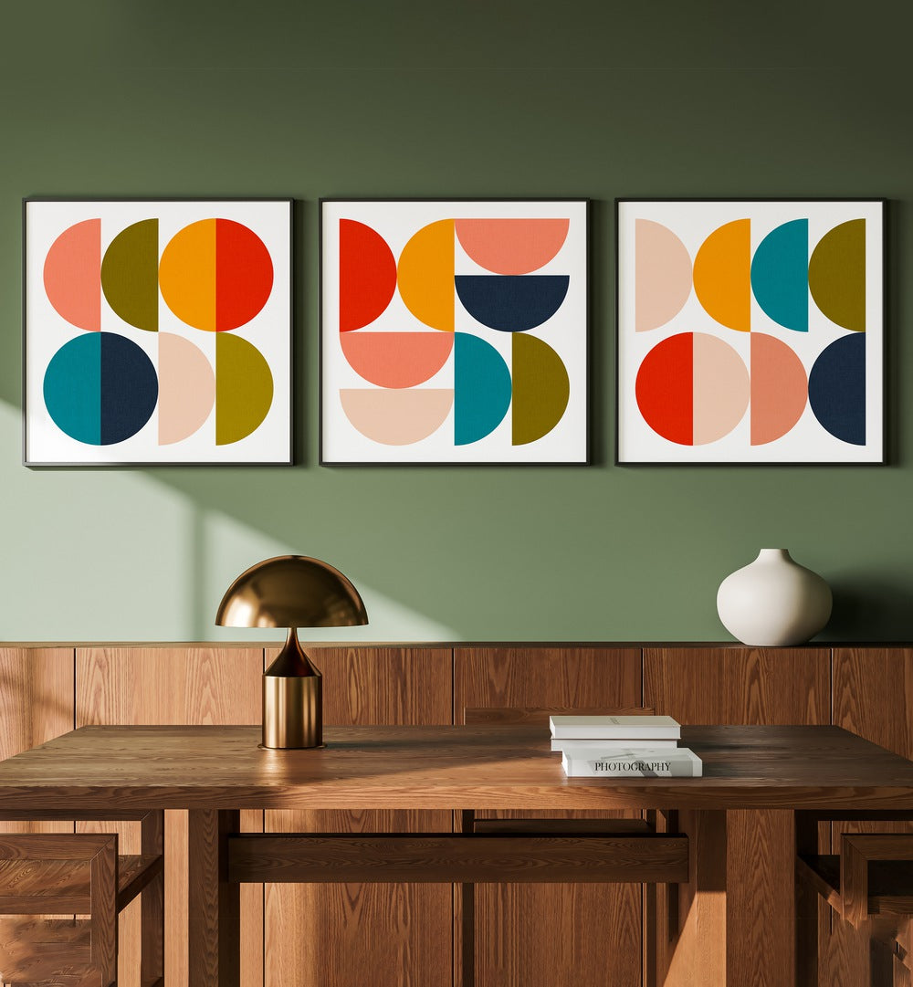 Mid-Century Geometrical Colour Play Set Of 3 Paintings in Black Plain Frame placed on a green wall behind a study table for study room