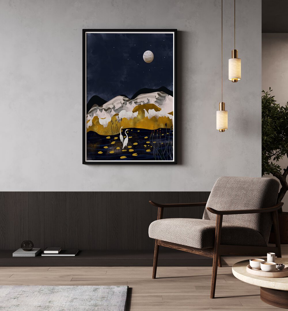 Midniight Lake By Uma Gokhale Landscape Art Prints in Black Plain Frame on a grey wall beside a chair