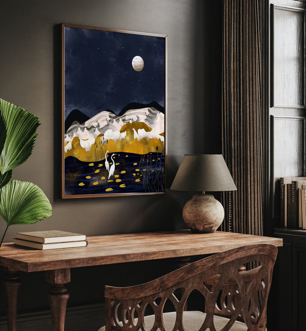 Midniight Lake By Uma Gokhale Landscape Art Prints in Dark wood frame on a wall above a study table