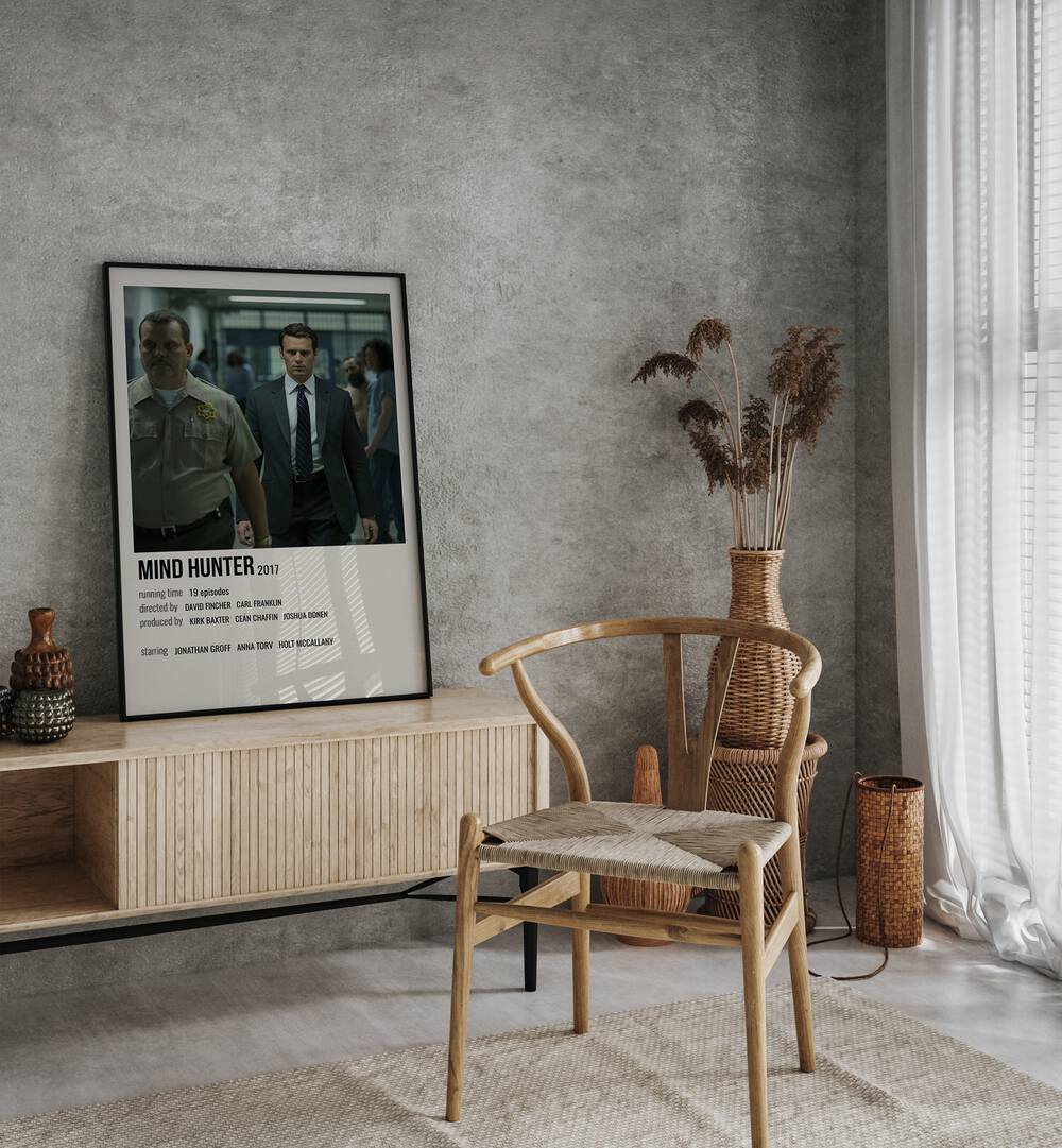 Mind Hunter 2017 Movie Posters in Black Plain Frame placed on a table beside oakwood chair