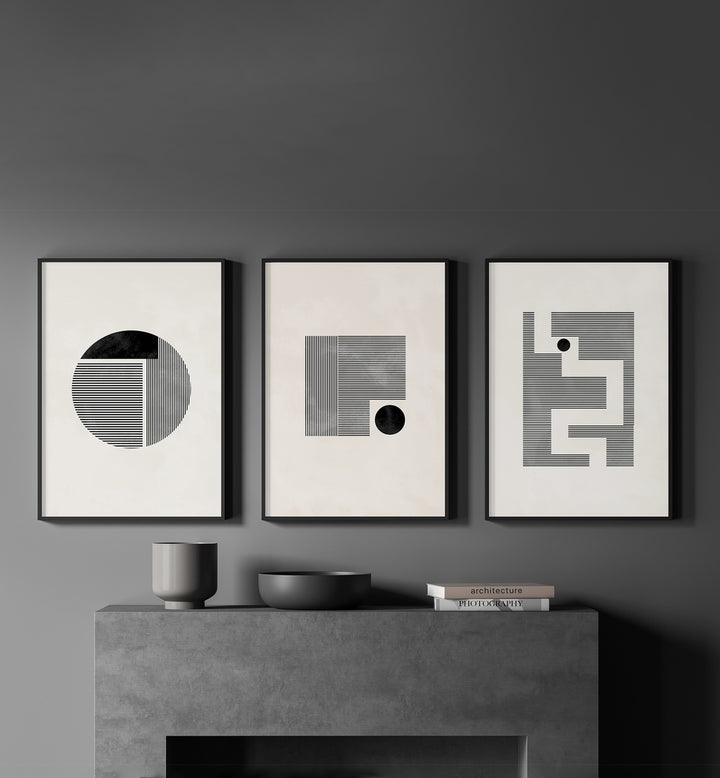 Minimalist Maze Set Set Of 3 Paintings in Black Plain Frame placed on a grey wall behind a shelf