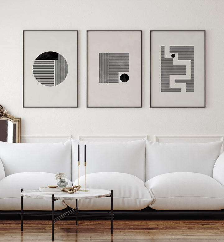 Minimalist Maze Set Set Of 3 Paintings in Black Plain Frame placed on a white wall behind a white sofa