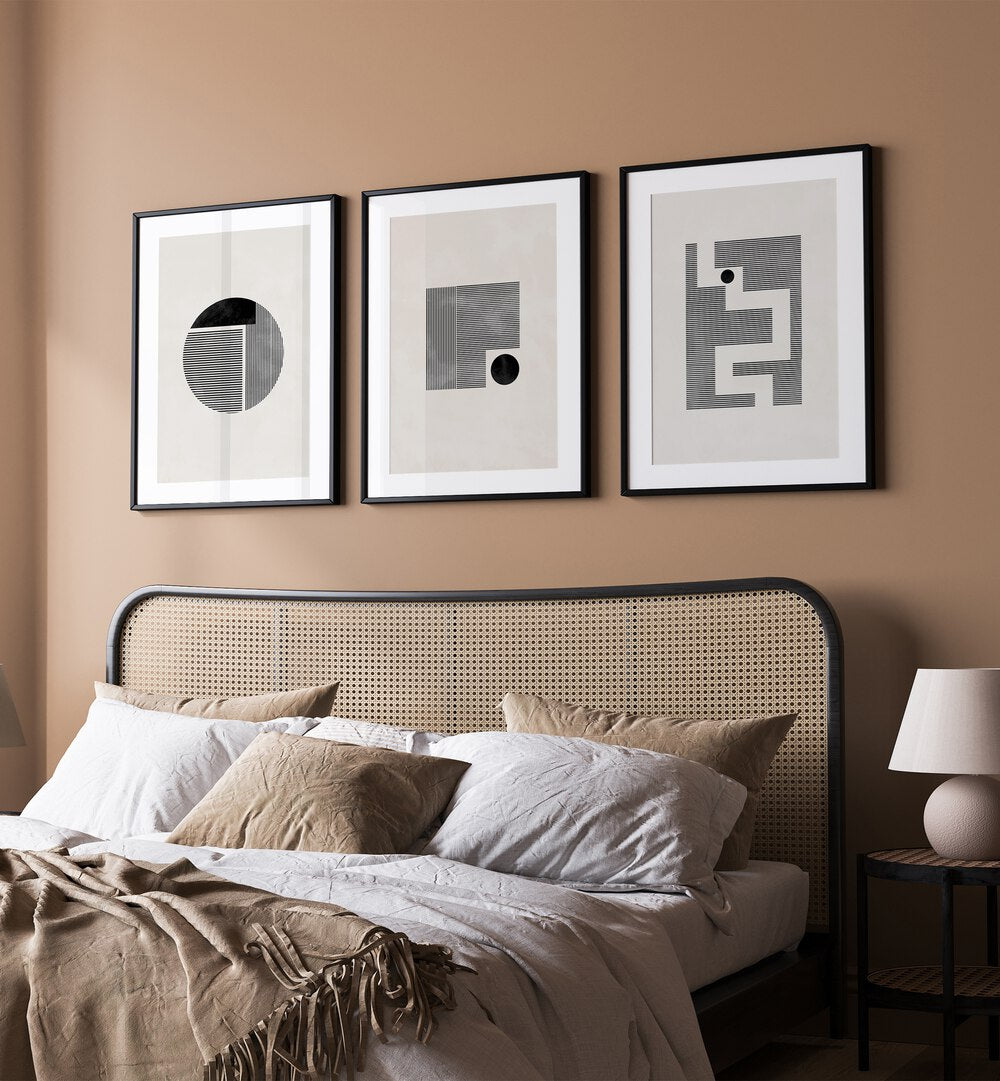 Minimalist Maze Set Set Of 3 Paintings in White Frame With Mount placed on a brown wall behind a bed for bedroom