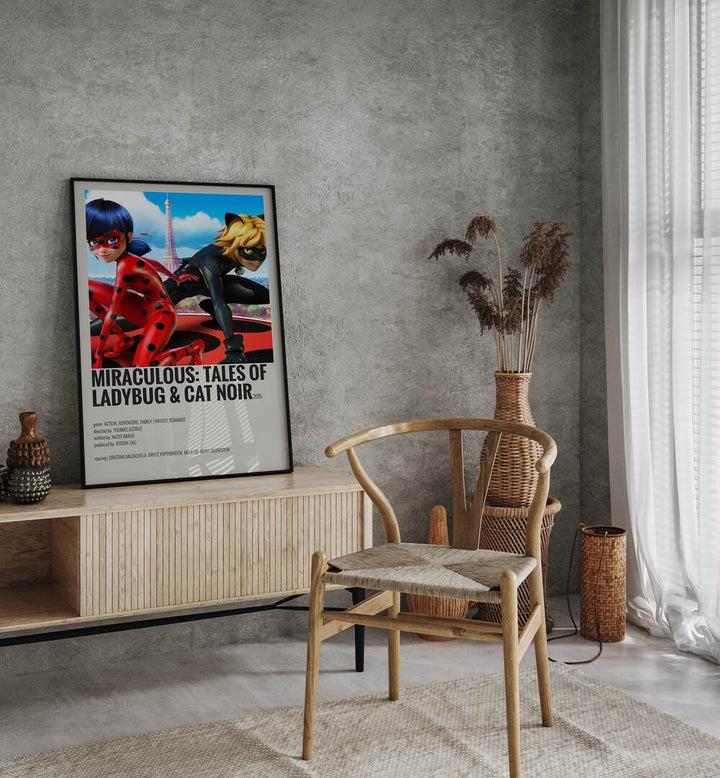 Miraculous tales Of Ladybug Cat Noir Movie Posters in Black Plain Frame placed on a table beside oakwood chair