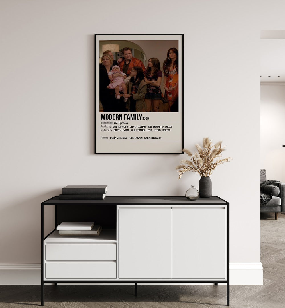 Modern Family 2009 Movie Posters in Black Plain Frame hanging on wall above console table