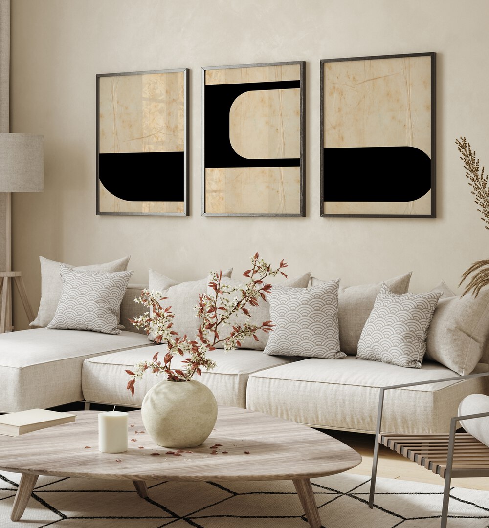 Modern Geometric Set Set Of 3 Paintings in Black Plain Frame placed on a beige wall behind a white sofa and beside a lamp