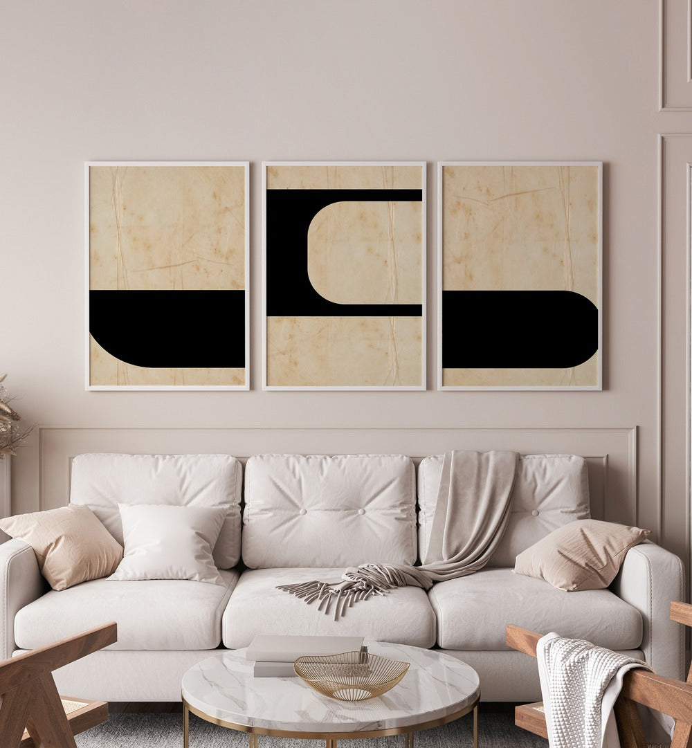 Modern Geometric Set Set Of 3 Paintings in White Plain Frame placed on a beige wall behind a white sofa 