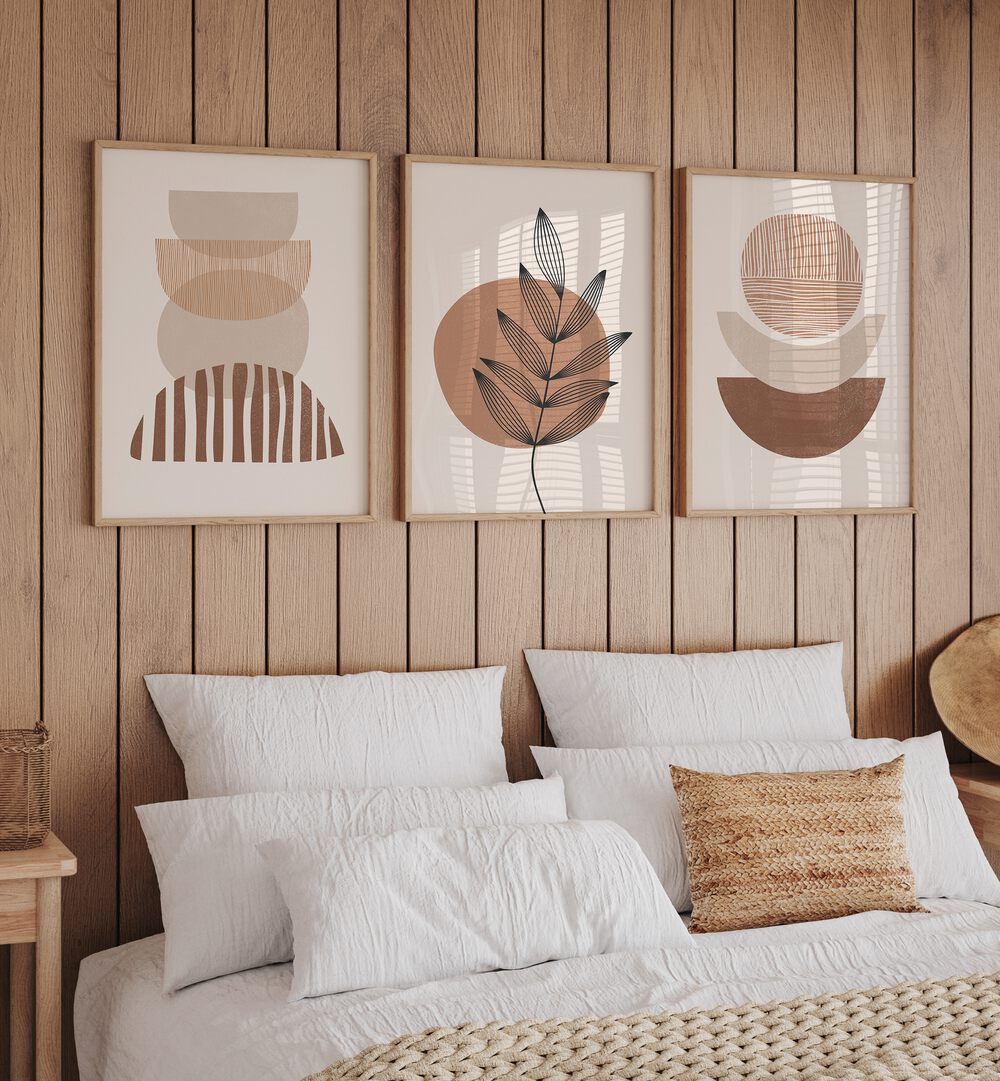 Modern Leaf Geometric Set Set Of 3 Paintings in Oak Wood Plain Frame placed on a bedroom wall behind a bed