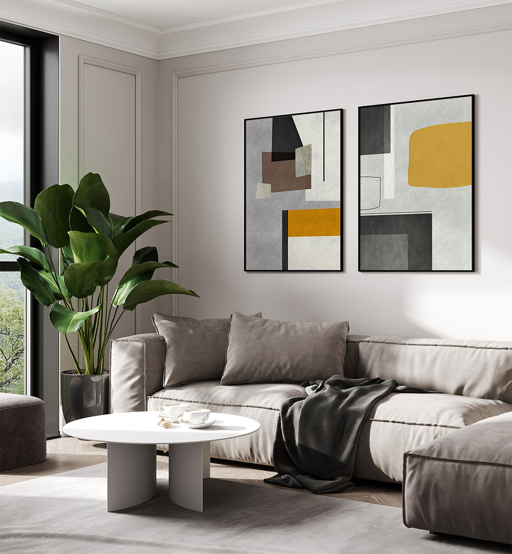 Modern living room with a gray sectional sofa, abstract art, and a plant.