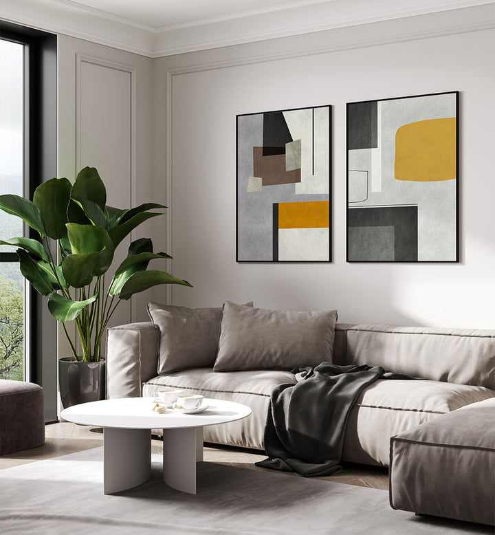 Modern living room with a gray sectional sofa, abstract art, and a plant.