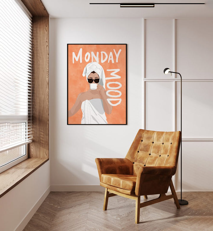 Monday Mood Portraits And Figurative Illustrations in Black Plain Frame placed on a Cream Colored Wall near a Brown Sofa Chair in the Drawing Room