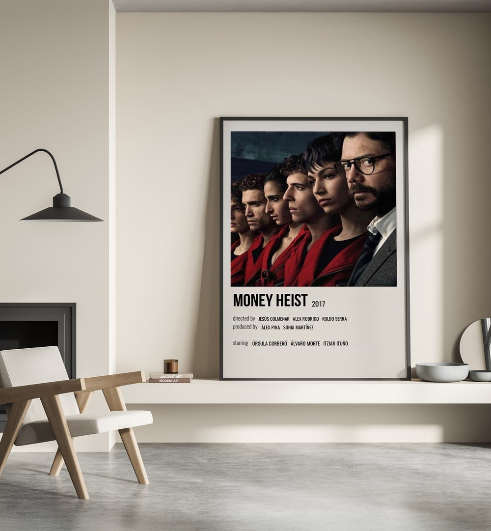 Money Heist 2017 I Movie Posters in Black Plain Frame place on a wall behind a chair beside lamp