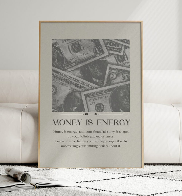 Money Is Energy By Grishma Korjani Money Art Prints in Oak Wood Plain Frame placed on a Floor near a White Sofa in the Living Room