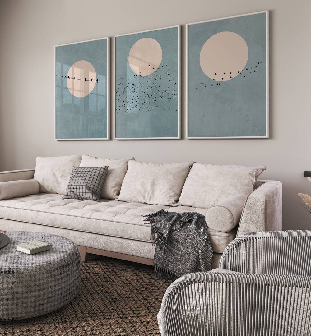 Moon Set Set Of 3 Paintings in White Plain Frame placed on a wall living room wall behind a sofa