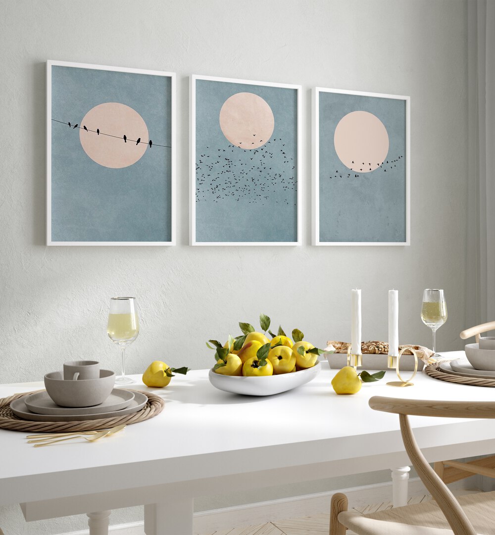 Moon Set Set Of 3 Paintings in White Plain Frame placed on the wall behind a dining table for dining area