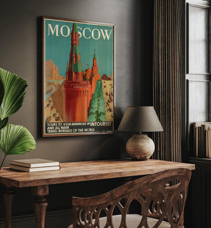 Moscow Retro Vintage Travel Vintage Travel Posters in Dark Wood Plain Frame on a wall above a study table beside a plant