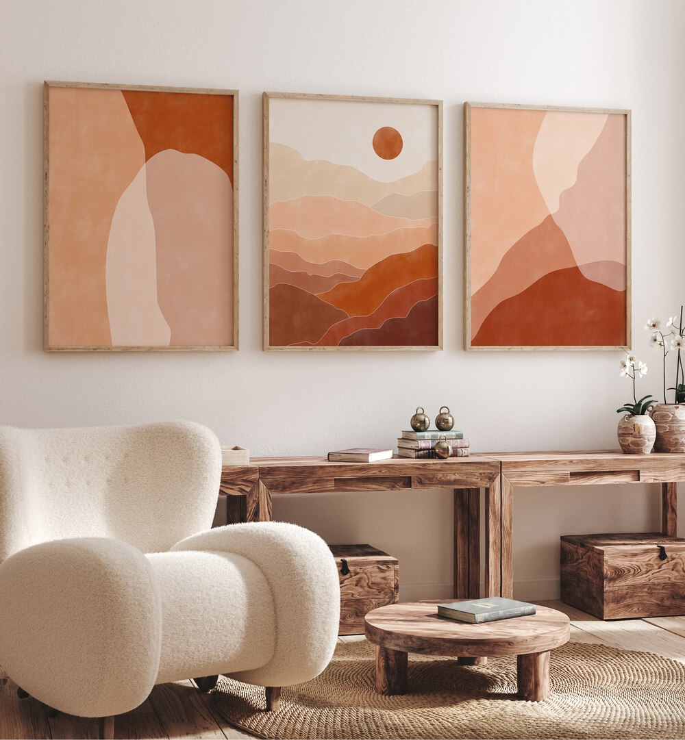 Nature Escapes Set Of 3 Paintings in Oak Wood Plain Frame placed on a white wall behind a table