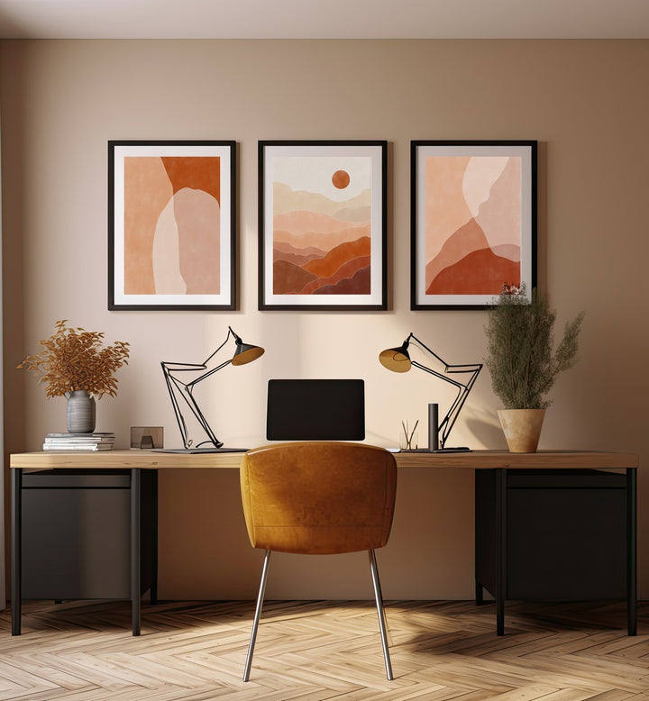 Nature Escapes Set Of 3 Paintings in Black Frame With Mount placed on a wall behind a study table