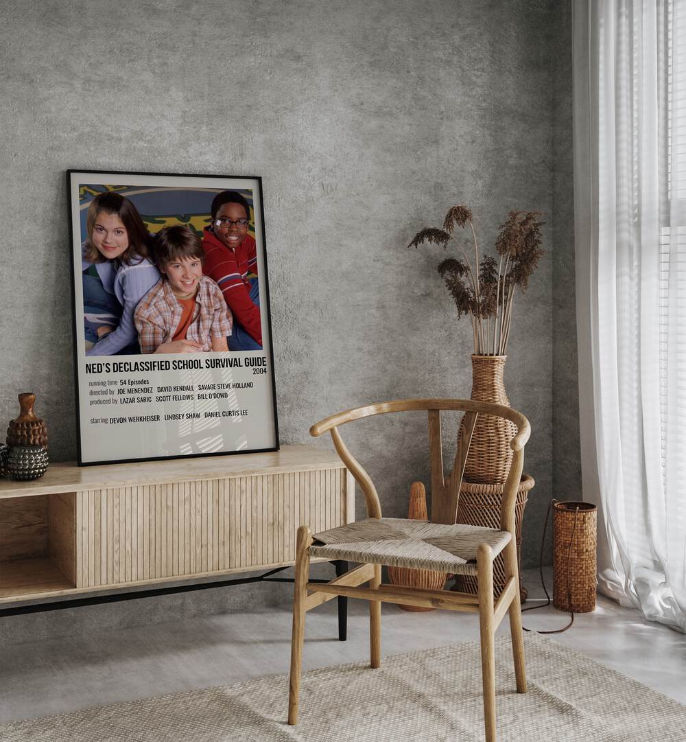 Neds Declassified School Survival Guide 2004 Movie Posters in Black Plain Frame placed on a table beside oakwood chair