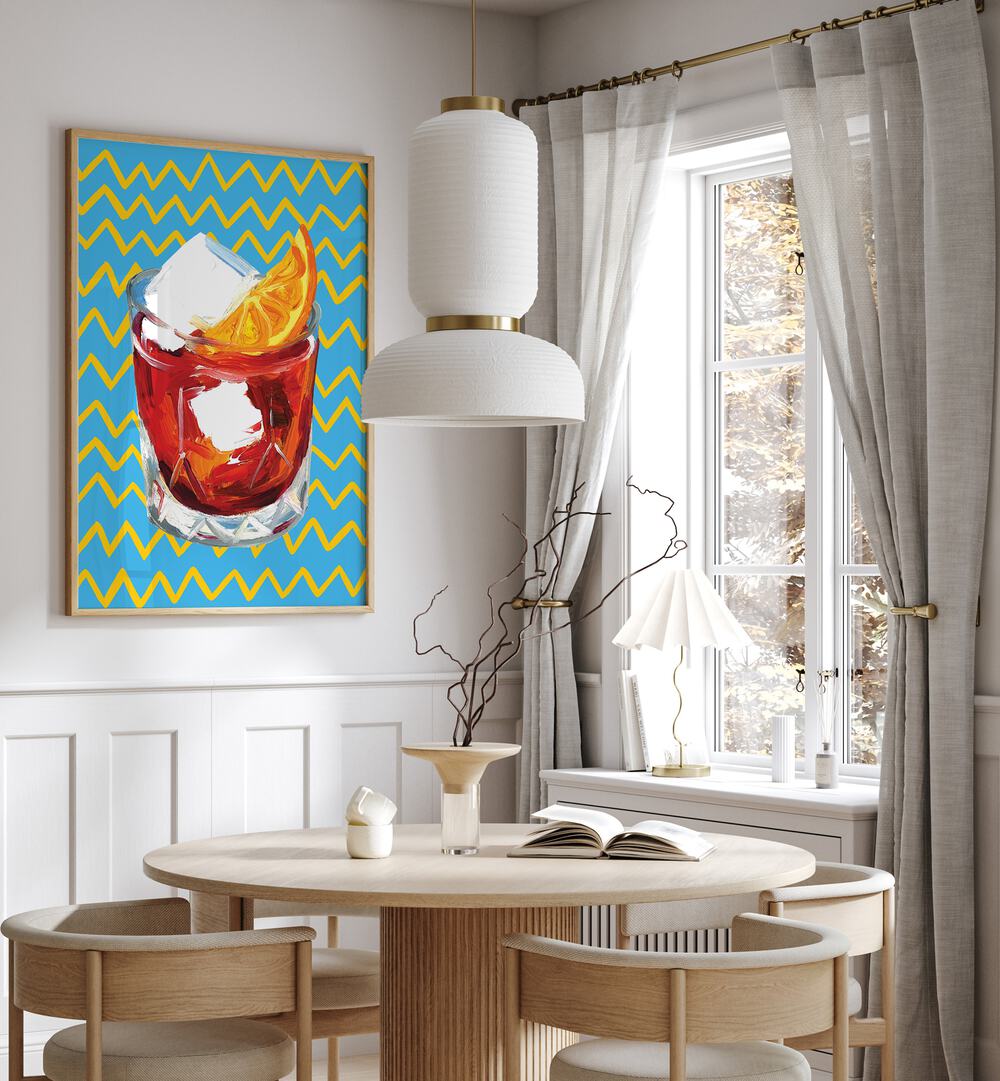 Negroni Blue by Alice Straker Bar Posters Bar Art Prints in Oak Wood Plain Frame placed on a wall in a dining room area beside a window and behind a dining table