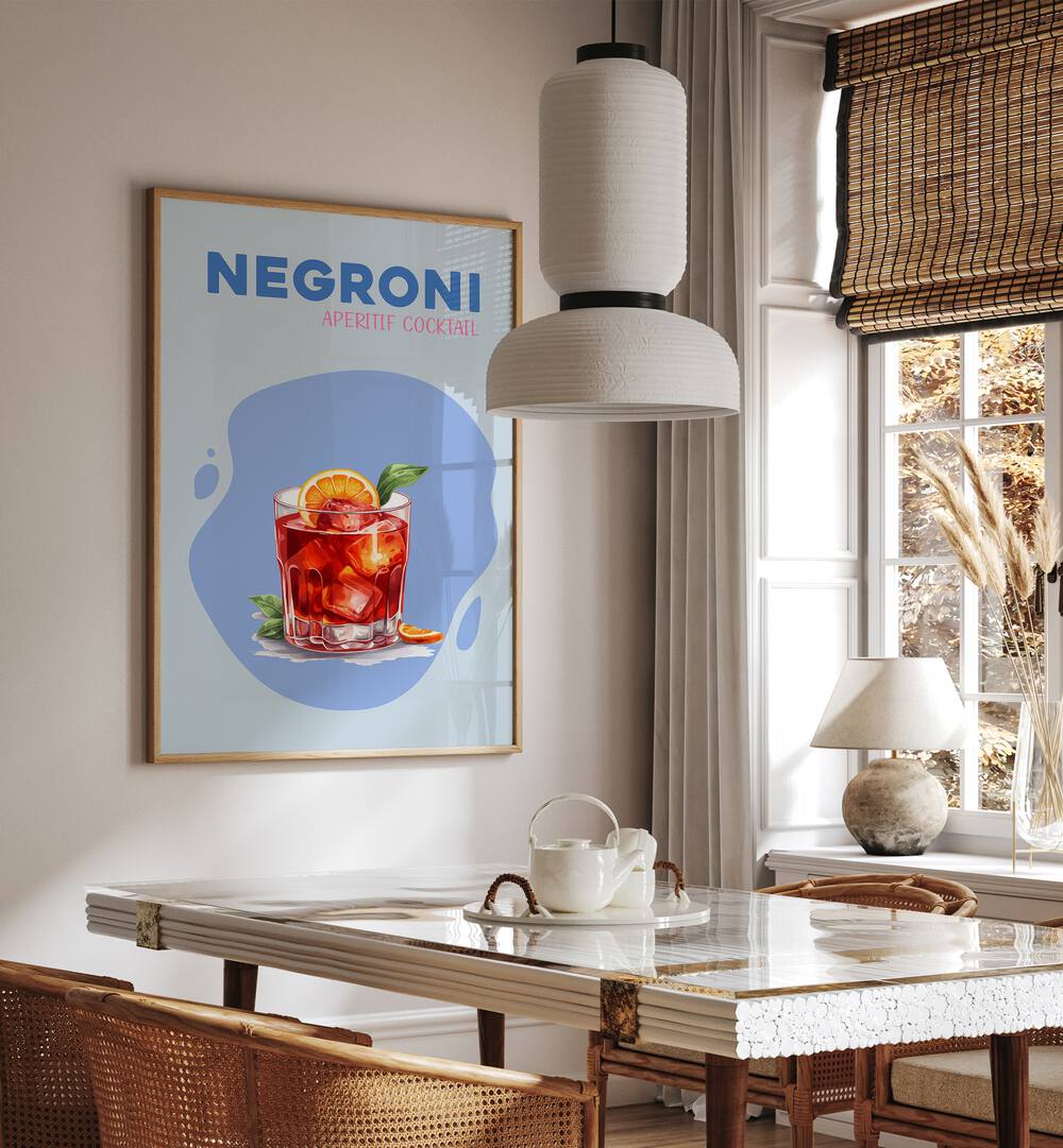 Negroni Cafe Art Prints Cafe Posters in Oak Wood Plain Frame placed on a wall in a dining room area beside a window and behind a dining table