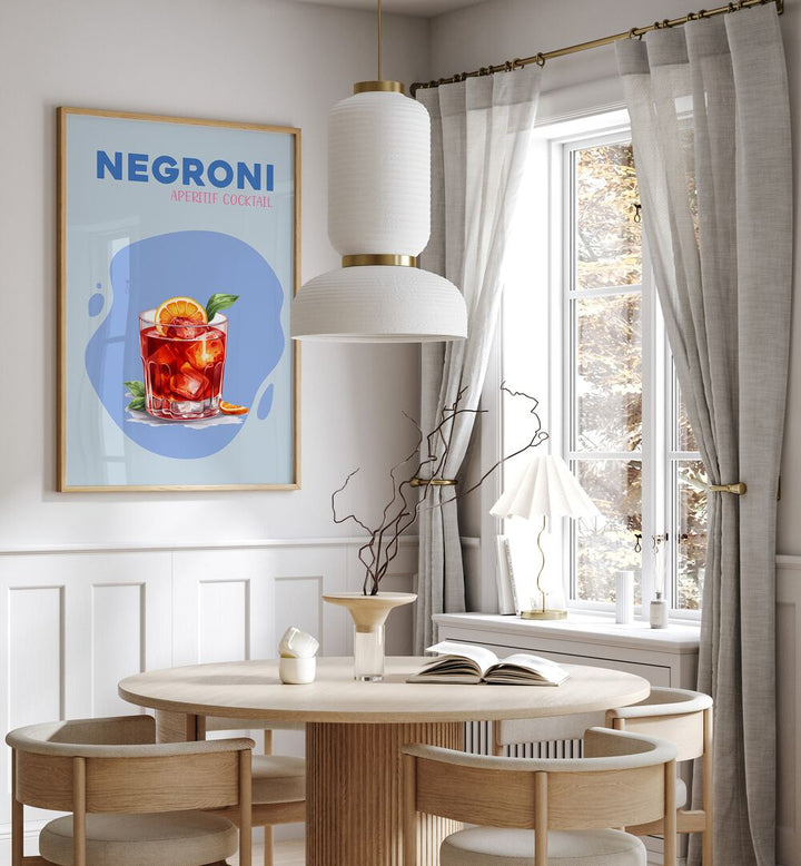 Negroni Cafe Art Prints Cafe Posters in Oak Wood Plain Frame placed on a wall in a dining room area beside a window and behind a dining table