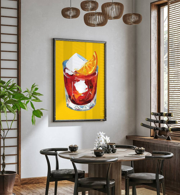 Negroni on Sunshine by Alice Straker Bar Posters Bar Art Prints in Black Plain Frame placed on a wall in a dining room area beside a window and behind a dining table