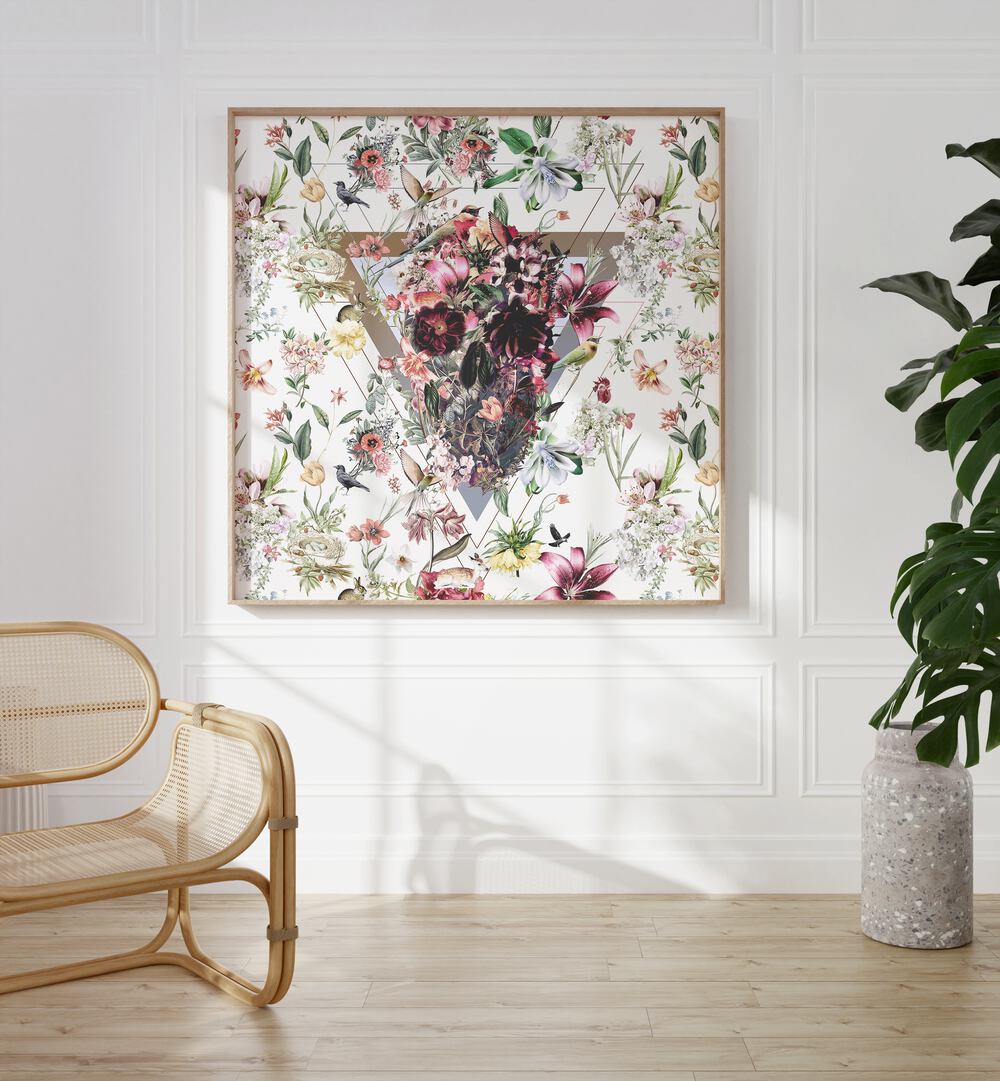 New Skull Light Botanical Art Prints Floral Paintings in Oak Wood Plain Frame placed on the wall between a chair and a plant