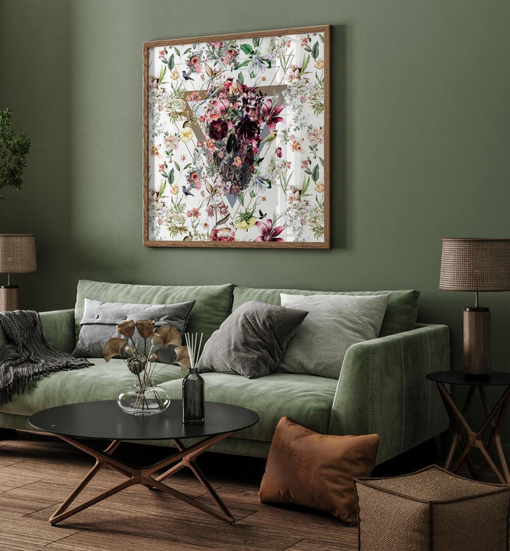 New Skull Light Botanical Art Prints Floral Paintings in Oak Wood Plain Frame placed on a living room wall behind a green sofa 