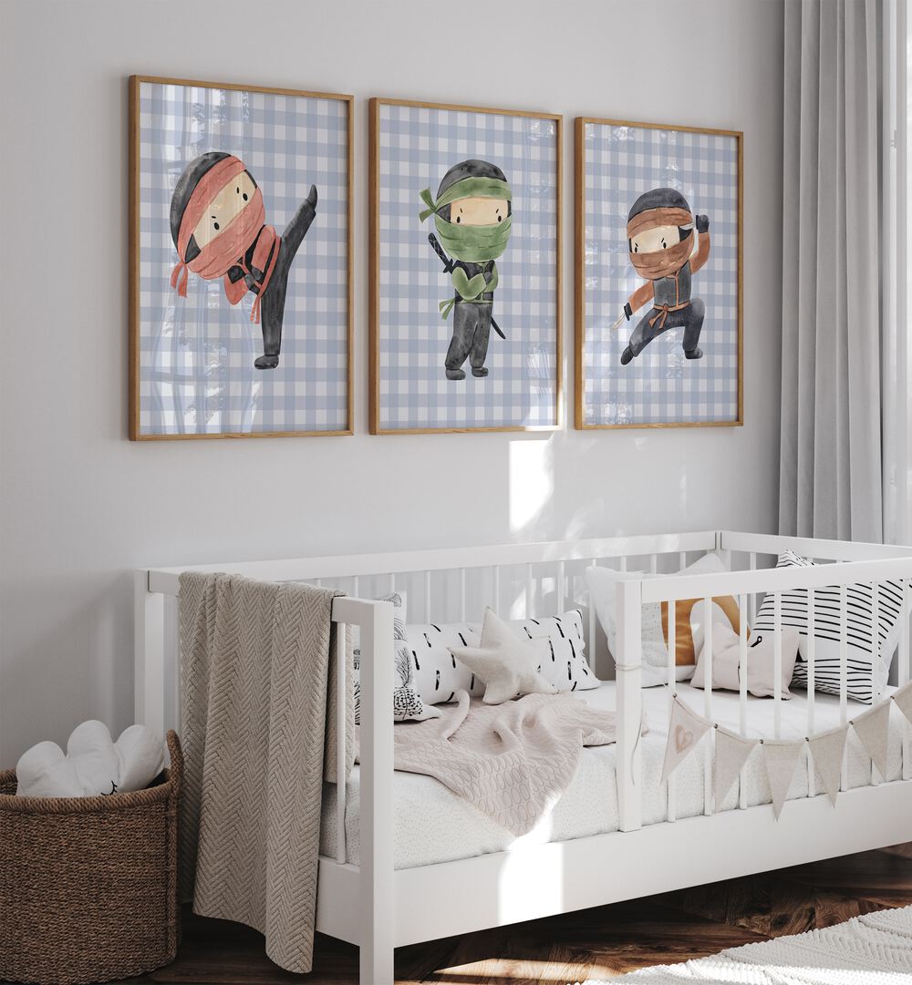 Ninja Set Of 3 Paintings in Oak Wood Plain Frame placed on a wall behind a white infant's bed for kids room